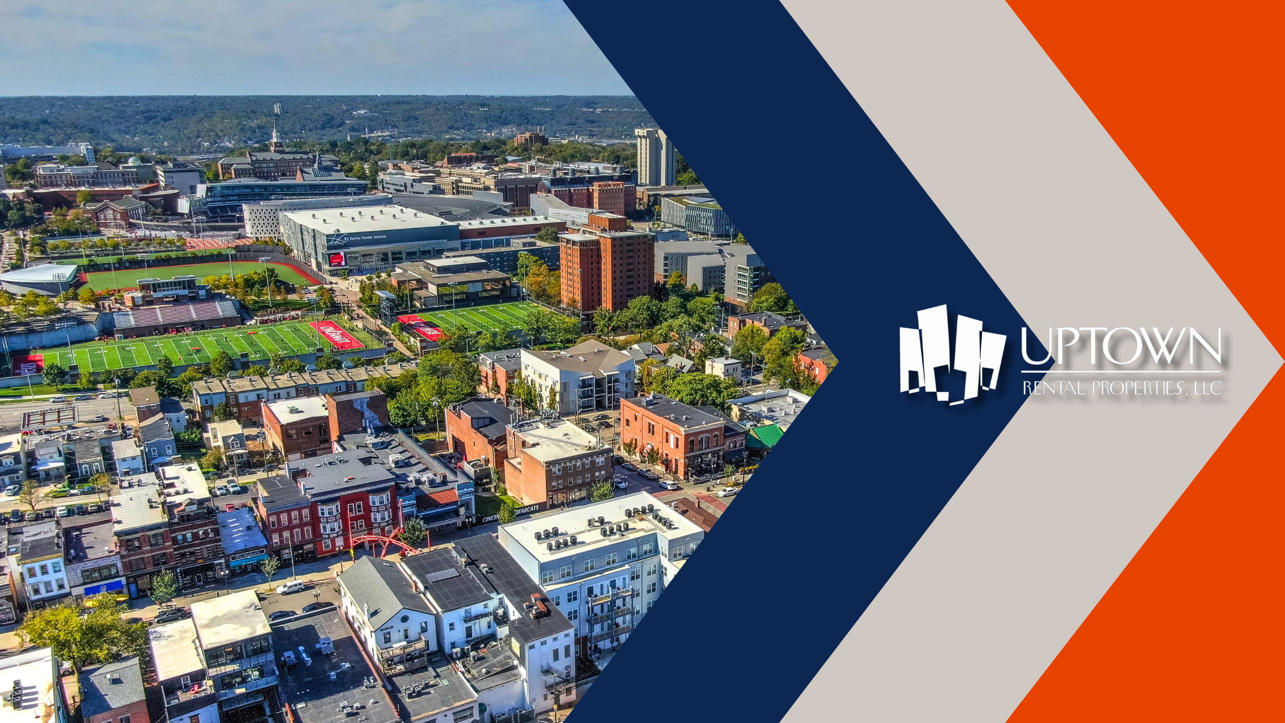 An aerial view of residential and commercial buildings in Cincinnati with the Uptown Rental Properties LLC logo.